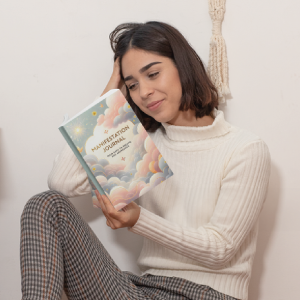 A reader holding the Belffy Books Manifestation Journal